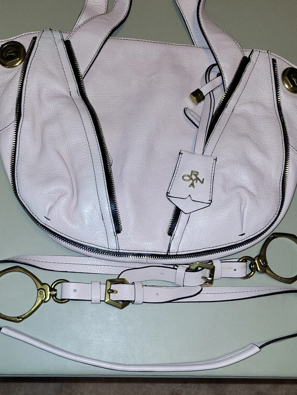 Oryany Blush Leather Shoulder Bag with Gold Turn-Lock Top Zip Bag.